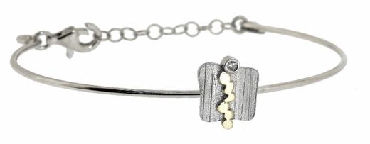 Pulsera fabricada en plata rodiada, oro de 18k y brillante de 0.015 ct. Una pieza atemporal